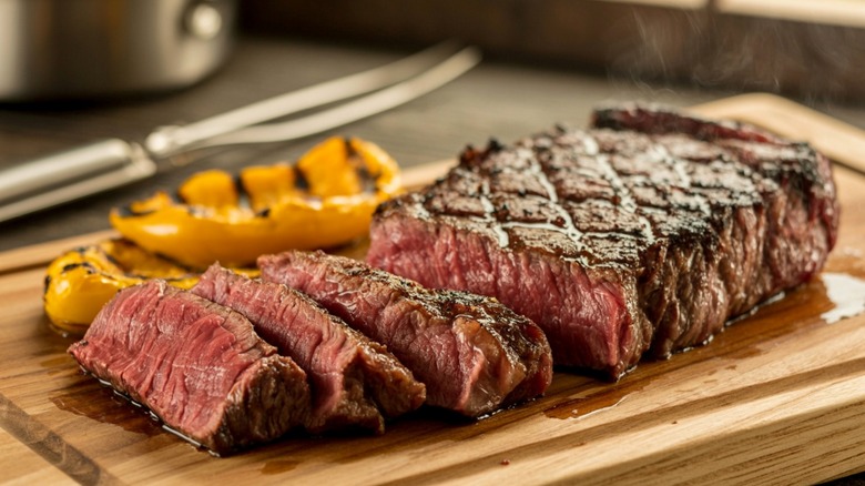 Grilled steak and bell pepper on cutting board