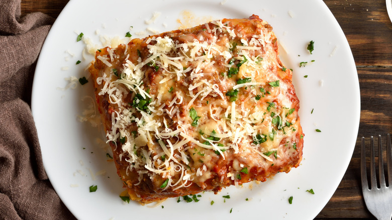 Top view of slice of lasagna on white plate
