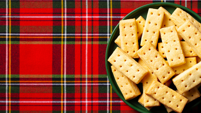 Traditional shortbread fingers on a green plate with a tartan background