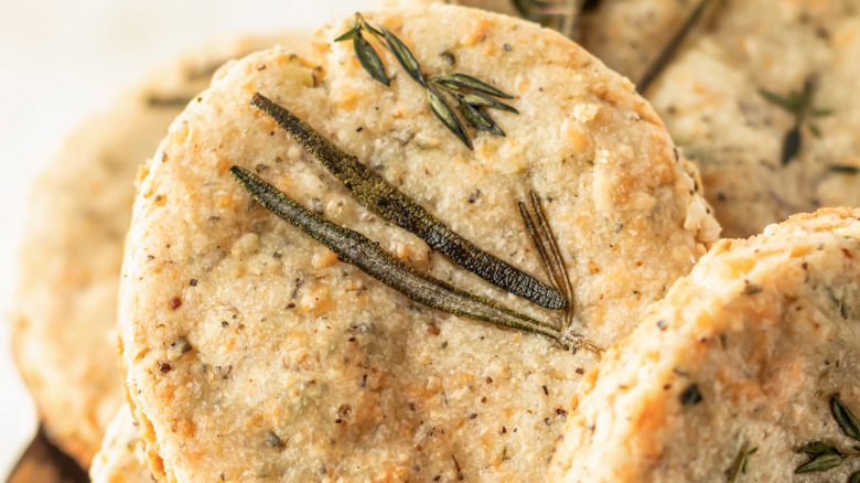 Close-up of savory shortbread rounds with rosemary and other herbs