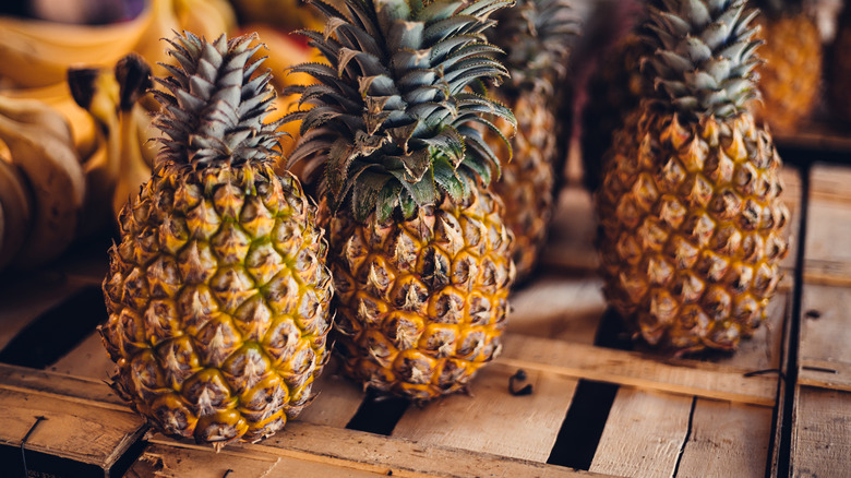 Pineapples sitting on a wooden box