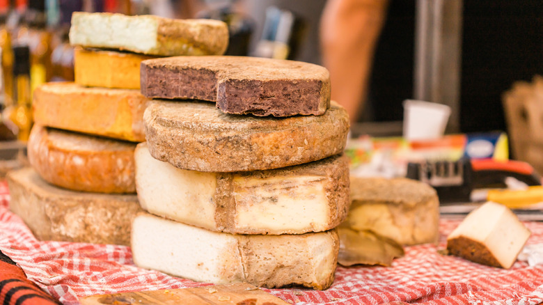 Wheels of cheese stacked on a table