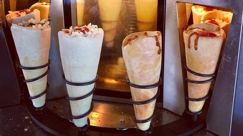 Pizza cones outside in a rack