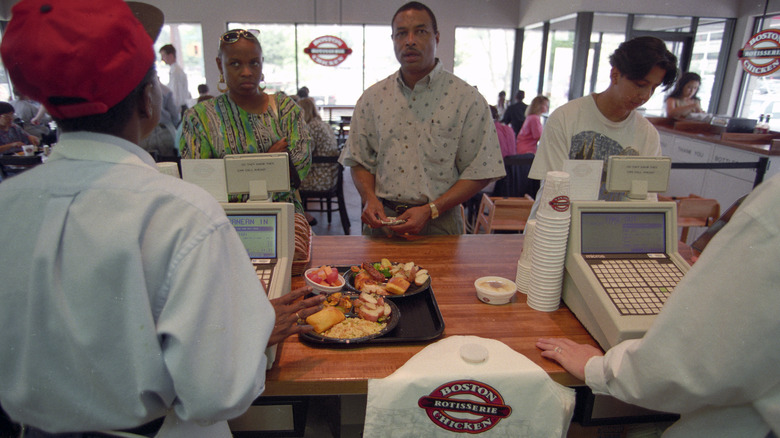 Customers buying food at an old Boston Chicken location