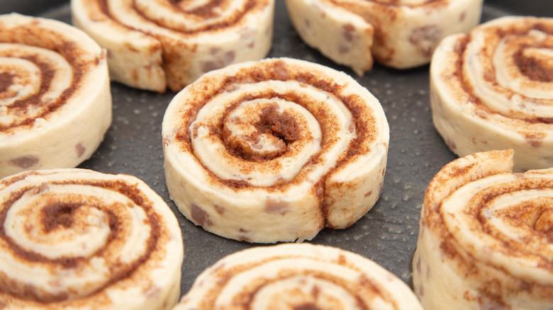 Unbaked, canned cinnamon rolls in a greased pan