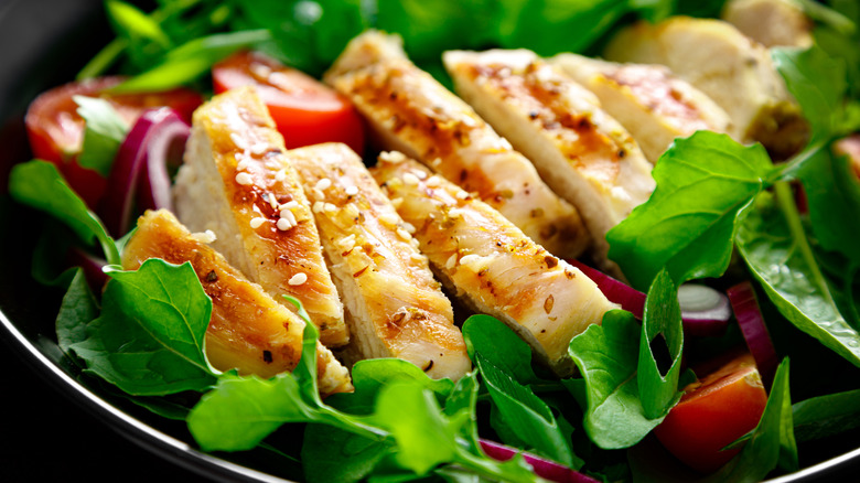 close-up of rotisserie-style chicken on salad