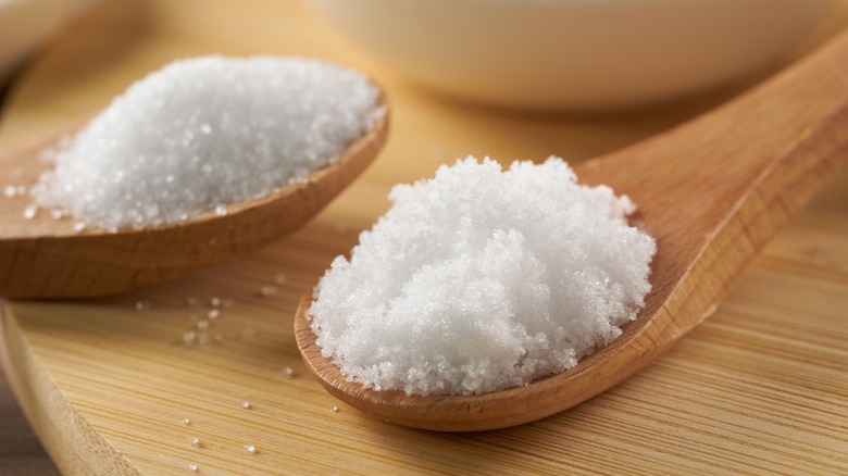 Caster sugar and table sugar in wood spoons