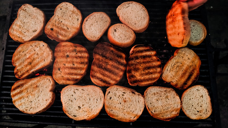 slices of bread being toasted on grill