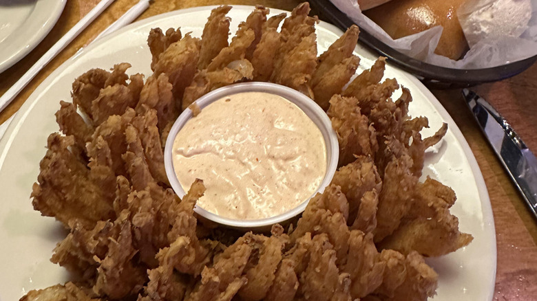 Cactus blossom fried onion at Texas Roadhouse on a plate.