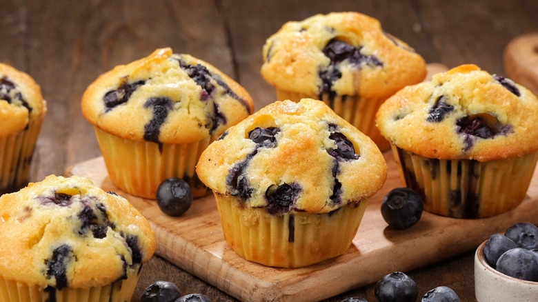 fluffly blueberry muffins on wooden board