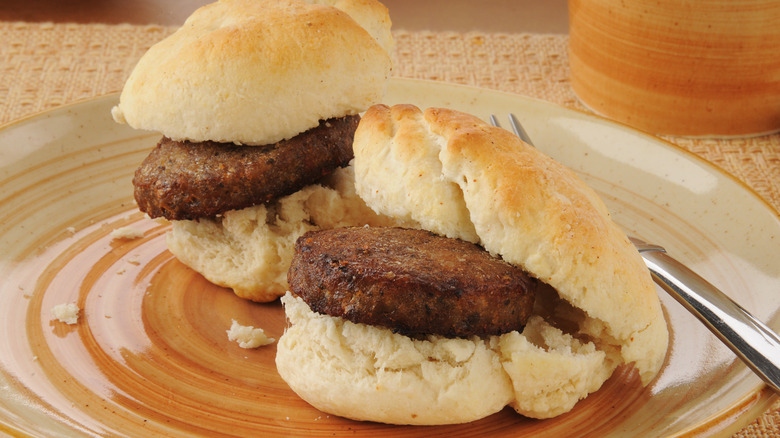 Closeup of two sausage biscuits on a plate