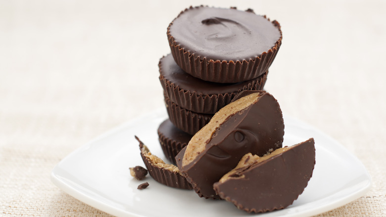 Stack of chocolate peanut butter cups on white plate