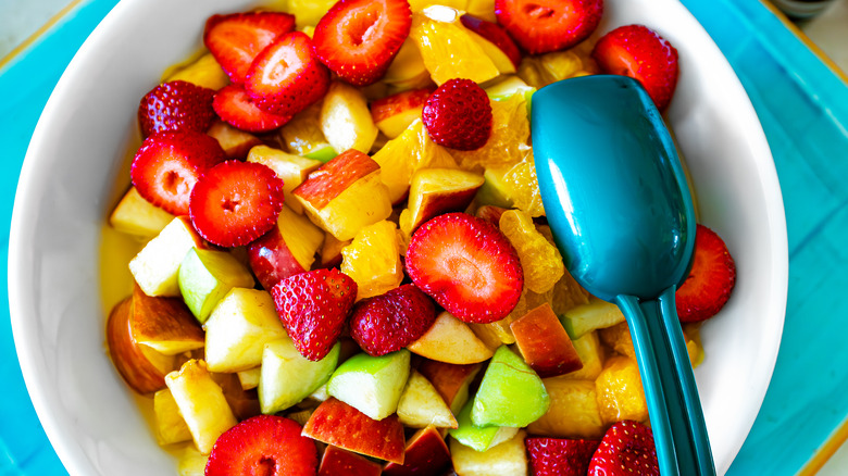 fruit salad with strawberries, apples, and oranges