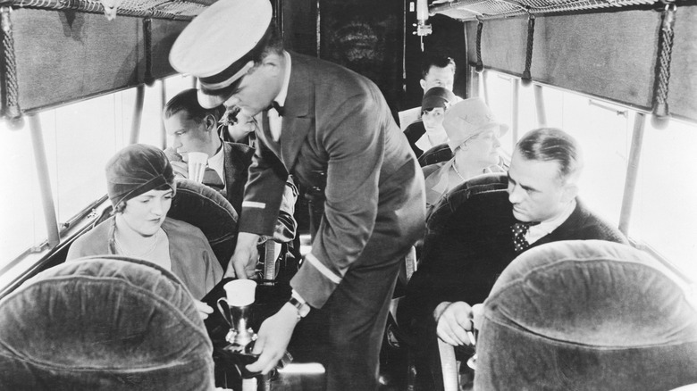 Male flight attendant on early 20th century airplane
