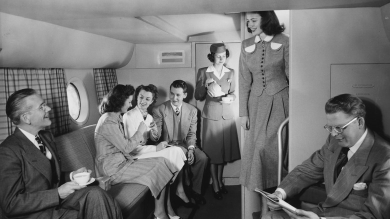 Pan Am flight attendants serve passengers