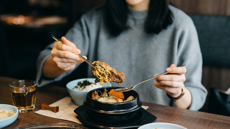woman eating Korean food