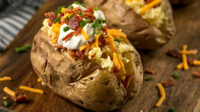 Loaded baked potato with cheese, sour cream, bacon, chives