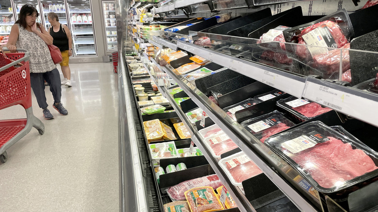 A person looks over the meat in the grocery department at Target