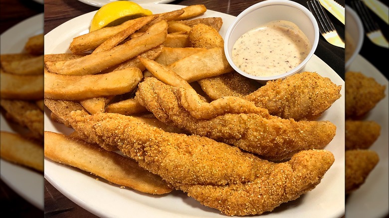 Texas Roadhouse fried catfish meal with fries and sauce