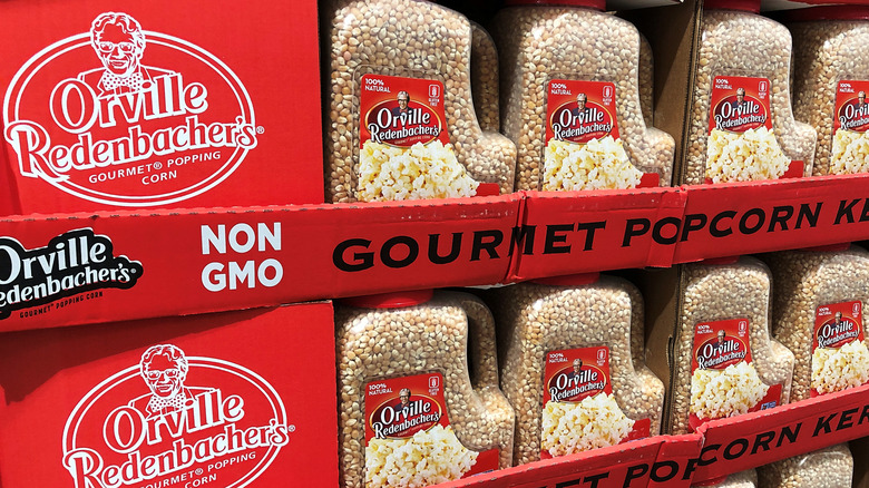 Grocery shelves stocked with Orville Redenbacher's popcorn kernels in jarred containers