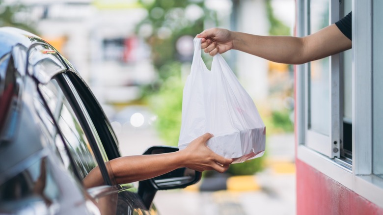 A customer in a drive-thru receives their order