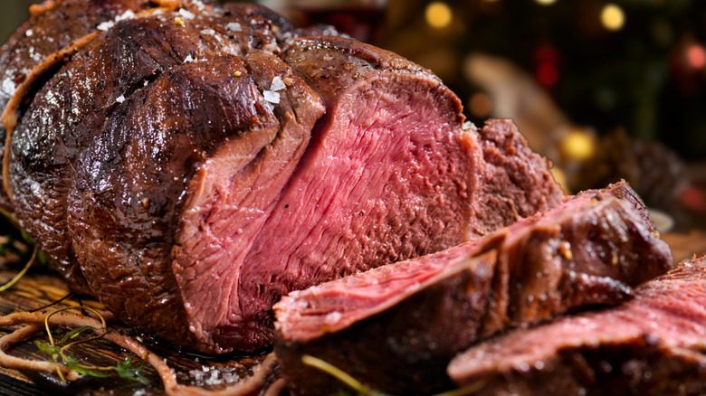 A closeup of a venison roast being sliced