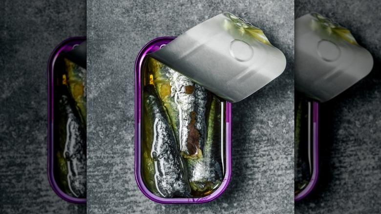 opened can of sardines on a solid surface