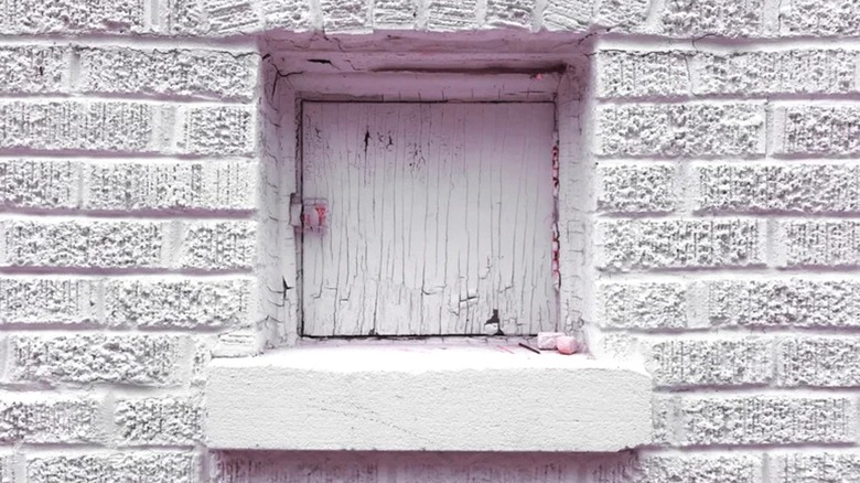 A pink milk door on the exterior of a house