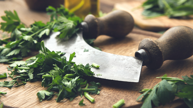 mezzaluna knife with chopped herbs