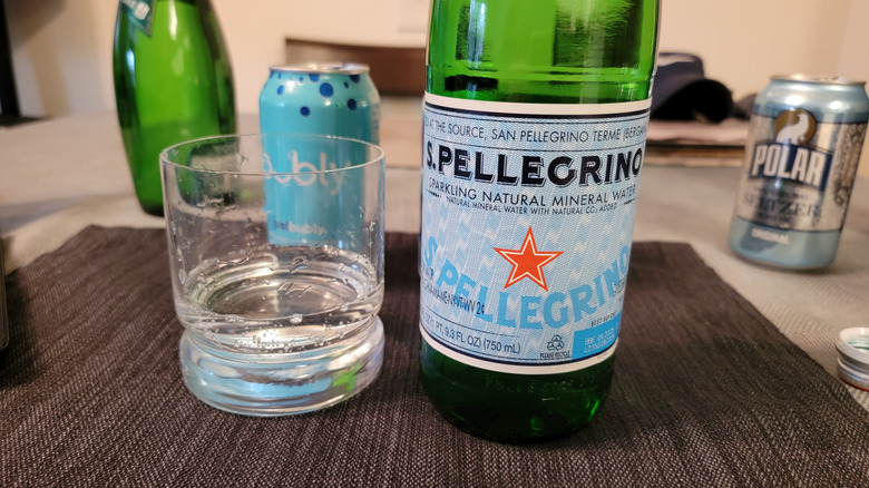 Bottle of San Pellegrino next to glass