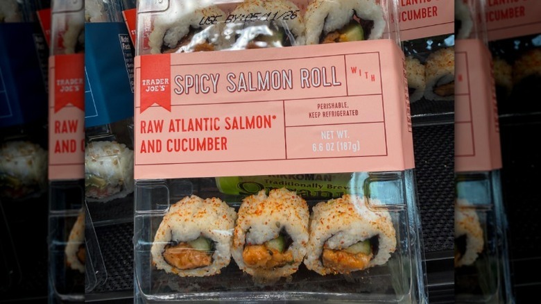 A sealed box of Trader Joe's Spicy Salmon Roll sushi in the store.