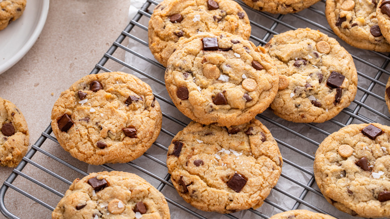 Chocolate chip cookies with flaky salt on a cooling rack