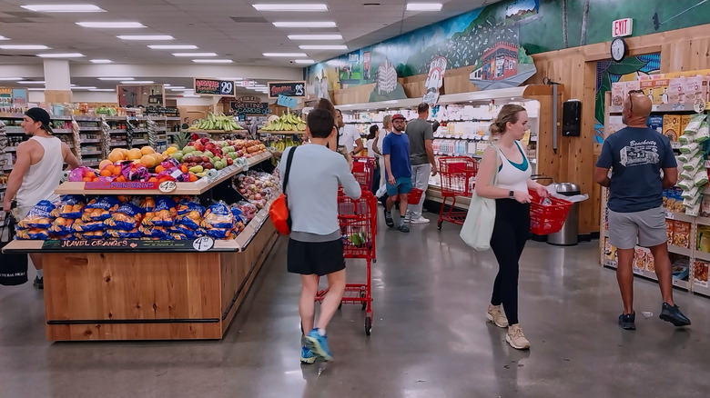 A Trader Joe's interior with shoppers walking around shopping.