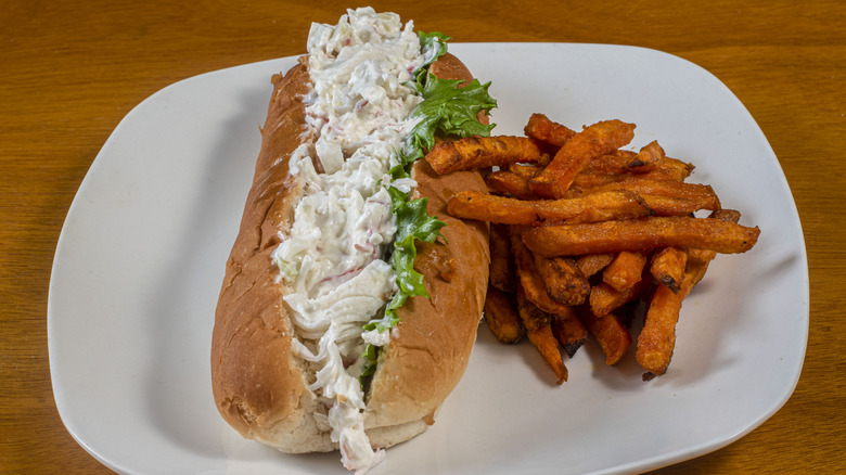 shrimp salad on a bun with lettuce and fries