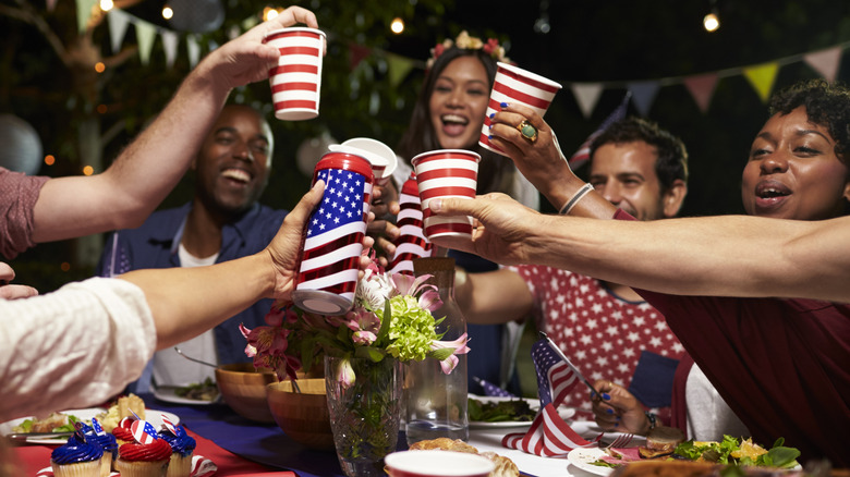 Group of people toasting with American flag cups