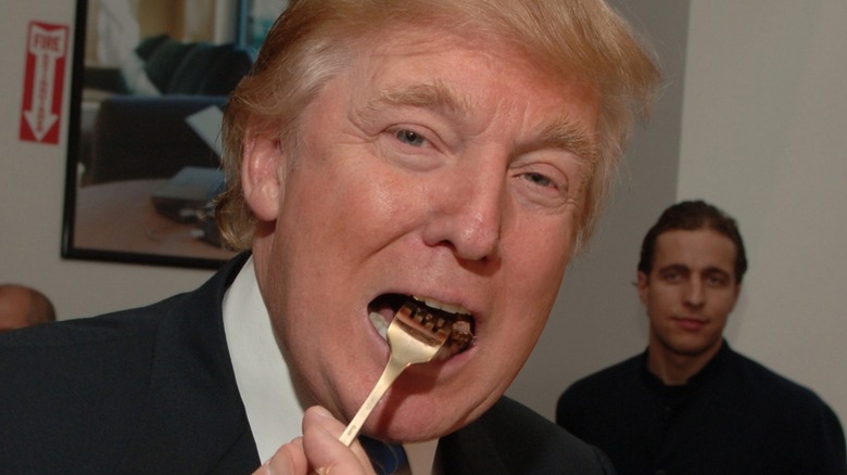 Donald Trump eating a piece of steak.