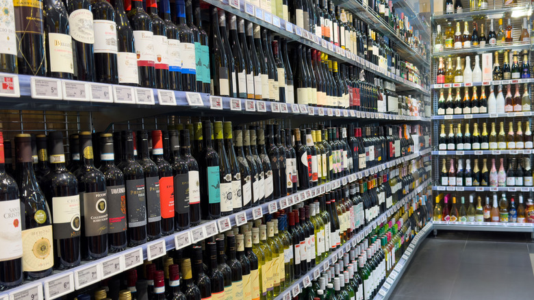 Two walls of wine on shelves in a store