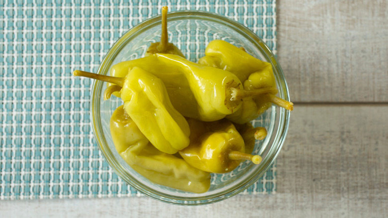 Pepperoncini in a glass bowl on a counter