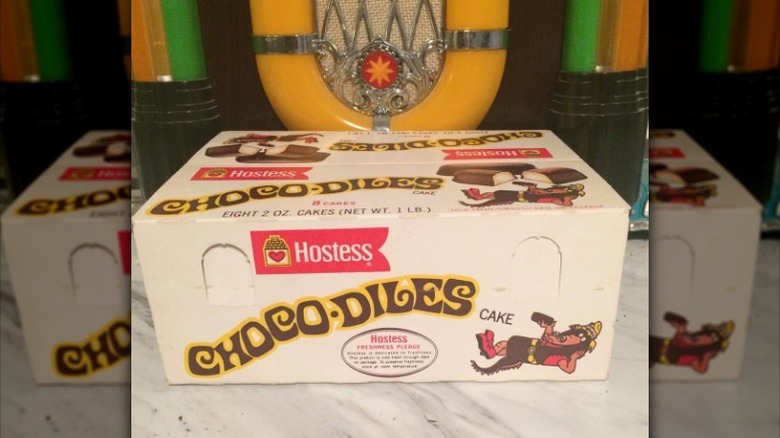 A box of Hostess Chocodiles in front of a vintage jukebox.