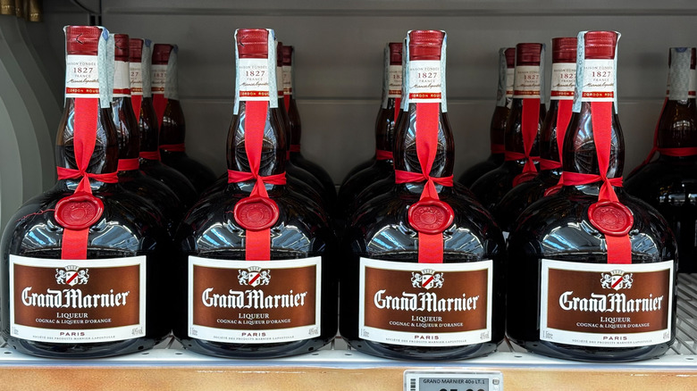 Four rows of Grand Marnier Liqueur for sale on a store shelf
