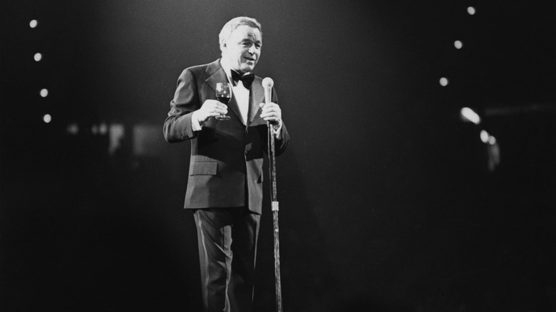 Black and white photo of Frank Sinatra enjoying a drink