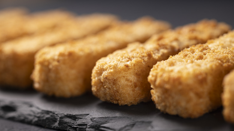 Vegan fish fingers lined up in a row