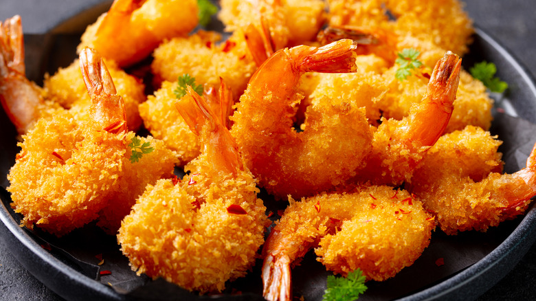 Fried shrimp on black plate