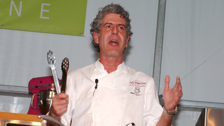 Anthony Bourdain cooking at an event.
