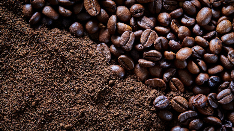 A mixture of roasted coffee beans and coffee grinds.
