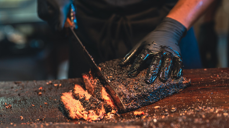 A BBQ chef prepares a delicious brisket