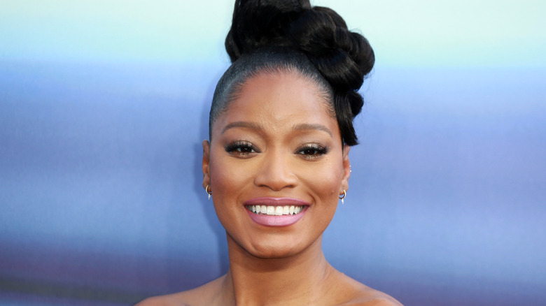 Keke Palmer smiling at red carpet party.