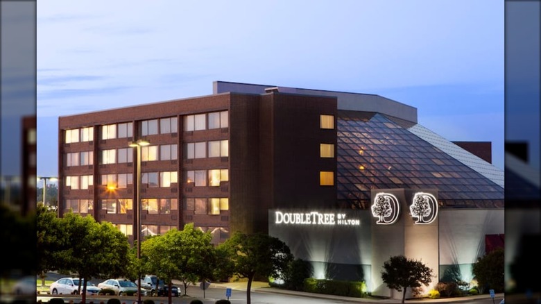 The outside of DoubleTree by Hilton with large glass roof in the early morning.