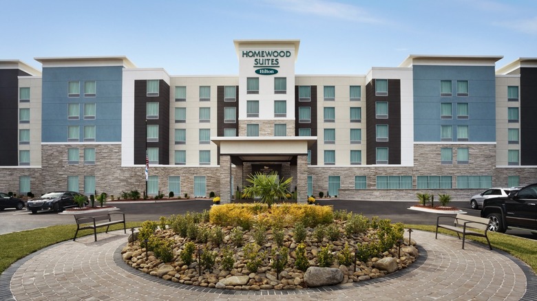 A Homewood Suites by Hilton with a large round courtyard and rock garden in front of the entrance.