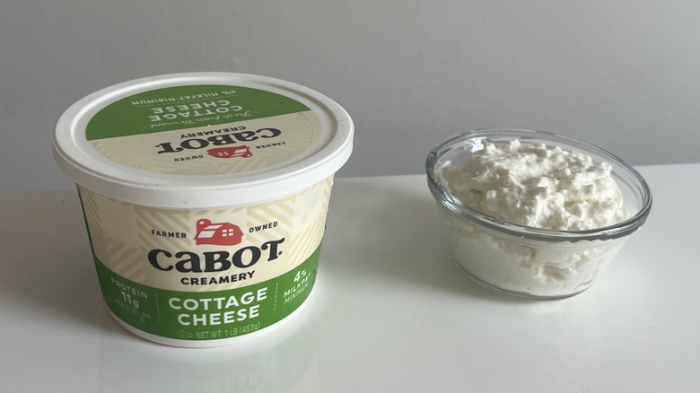 A tub of Cabot Creamery cottage cheese alongside a bowl of it